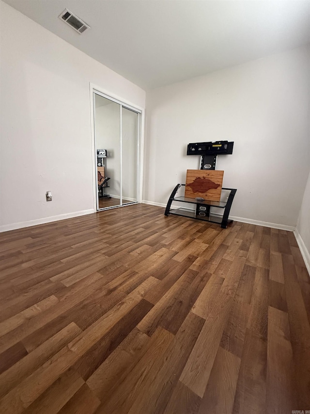 empty room with wood finished floors and baseboards