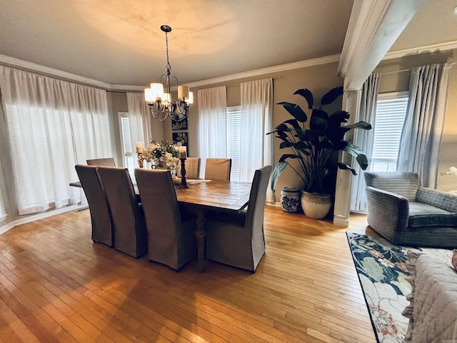615 Miller Cv, Benton, AR 72019 - dining room featuring a chandelier, light wood-type flooring, and crown molding