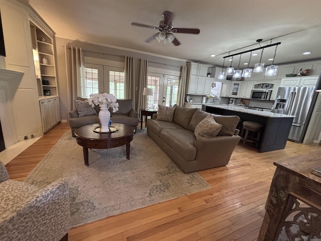 615 Miller Cv, Benton, AR 72019 - living area featuring light wood-style floors, a ceiling fan, french doors, and crown molding