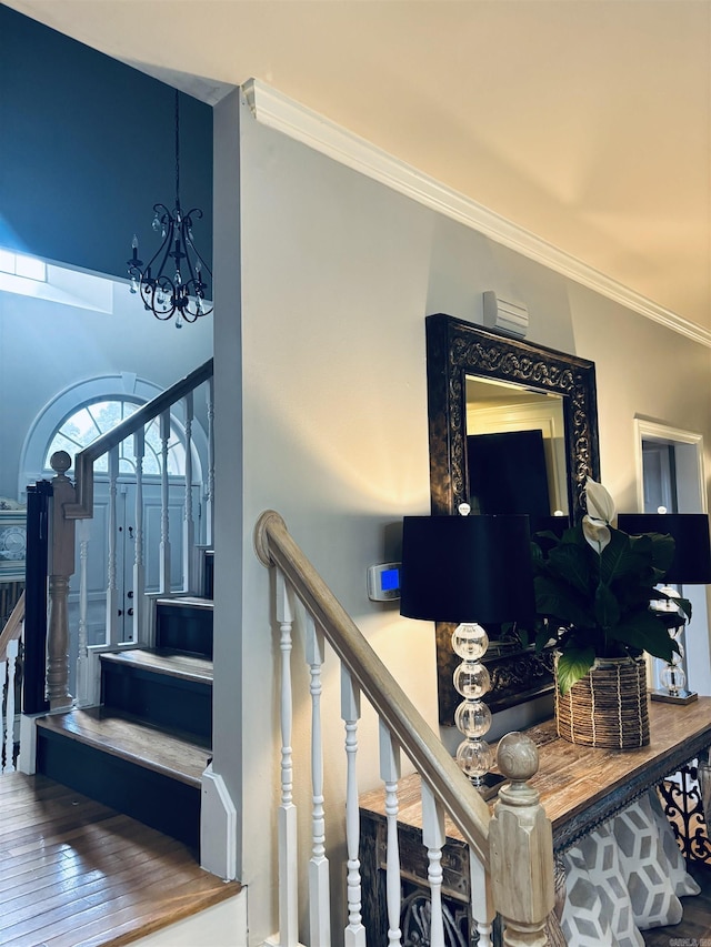 615 Miller Cv, Benton, AR 72019 - staircase featuring ornamental molding, hardwood / wood-style flooring, and a chandelier