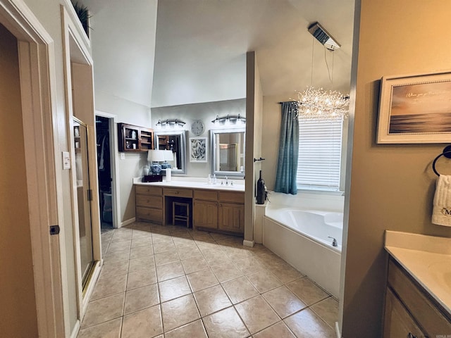 615 Miller Cv, Benton, AR 72019 - full bathroom featuring vanity, tile patterned floors, a garden tub, a chandelier, and vaulted ceiling