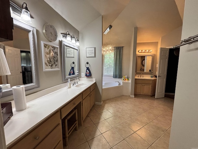 615 Miller Cv, Benton, AR 72019 - bathroom with a garden tub, tile patterned flooring, two vanities, a chandelier, and vaulted ceiling