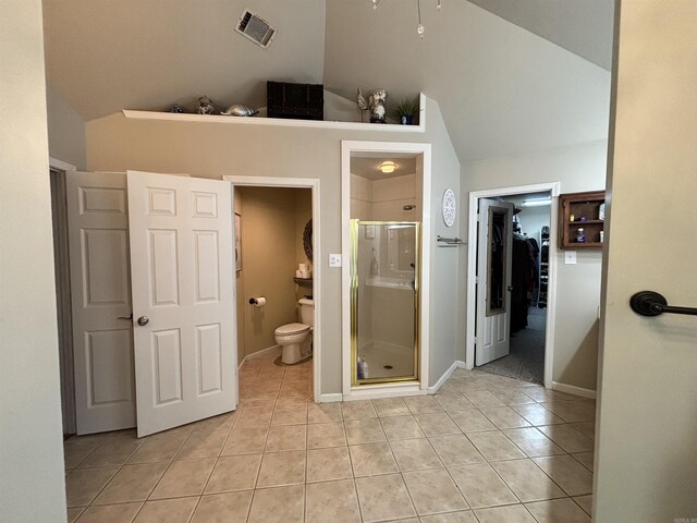 615 Miller Cv, Benton, AR 72019 - full bathroom featuring vaulted ceiling, tile patterned floors, a stall shower, toilet, and a spacious closet