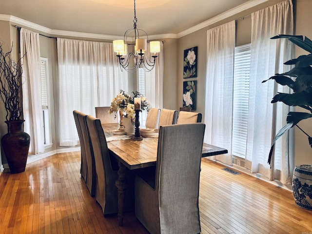 615 Miller Cv, Benton, AR 72019 - dining space featuring a chandelier, hardwood / wood-style floors, and ornamental molding