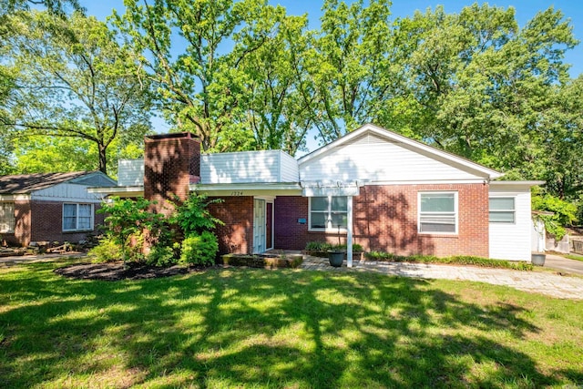 1224 S Fillmore St, Little Rock, AR 72204 - view of front of home featuring brick siding, a front lawn, and a chimney