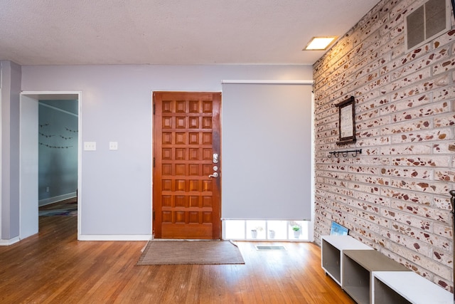 1224 S Fillmore St, Little Rock, AR 72204 - foyer entrance with wood finished floors, baseboards, and a textured ceiling