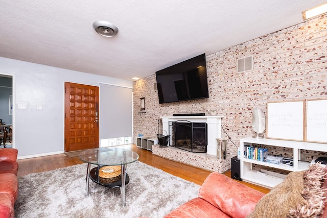 1224 S Fillmore St, Little Rock, AR 72204 - living area featuring wood finished floors and a fireplace with raised hearth