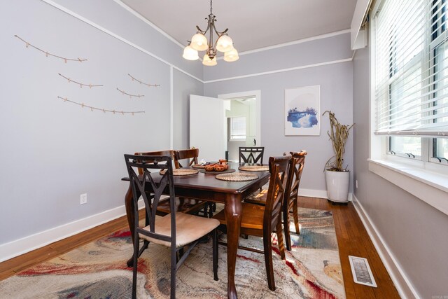 1224 S Fillmore St, Little Rock, AR 72204 - dining room with a chandelier, wood finished floors, baseboards, and crown molding