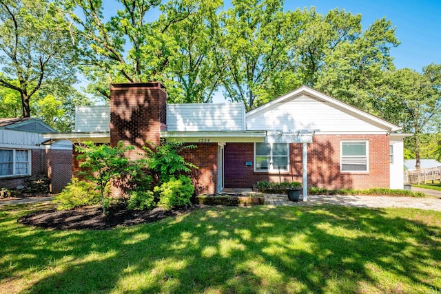 1224 S Fillmore St, Little Rock, AR 72204 - view of front of house featuring a front yard, brick siding, and a chimney