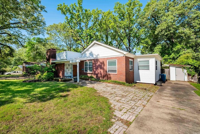 1224 S Fillmore St, Little Rock, AR 72204 - view of front of home with a storage unit, driveway, brick siding, a chimney, and a front yard