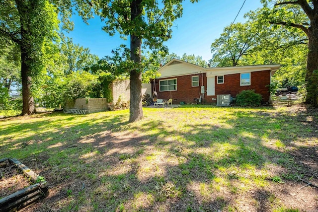 1224 S Fillmore St, Little Rock, AR 72204 - back of property with brick siding, a lawn, and central air condition unit