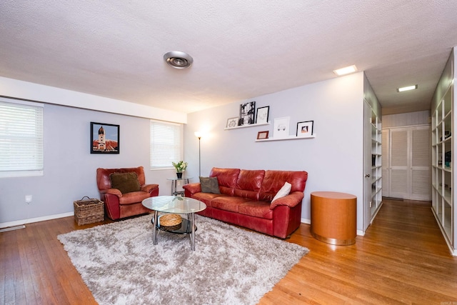 1224 S Fillmore St, Little Rock, AR 72204 - living room featuring wood finished floors, baseboards, and a textured ceiling