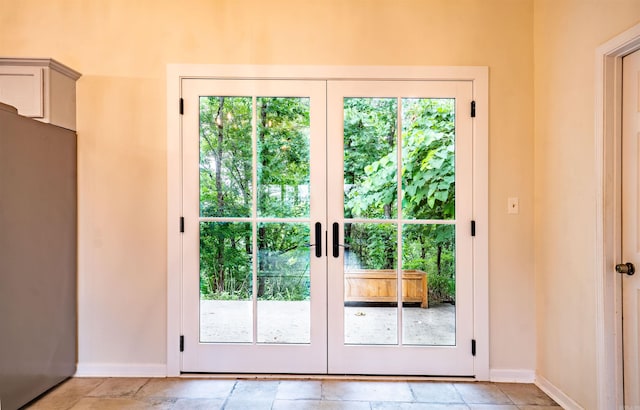 doorway to outside featuring french doors and baseboards