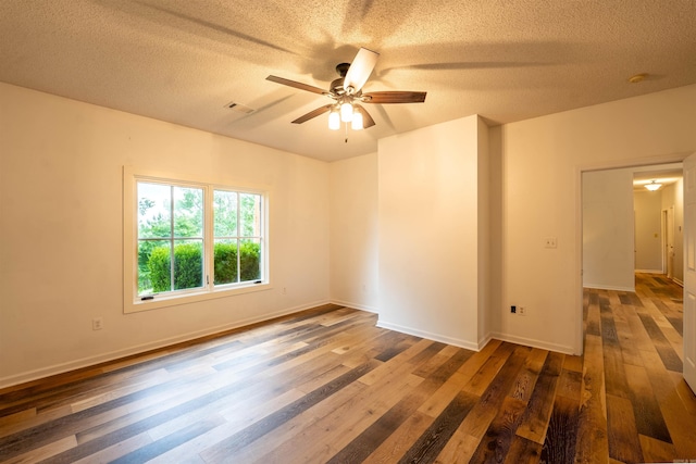unfurnished room featuring a textured ceiling, hardwood / wood-style floors, ceiling fan, and baseboards