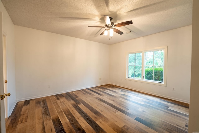 unfurnished room with wood finished floors, ceiling fan, a textured ceiling, and baseboards