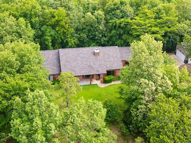 view of subject property with a forest