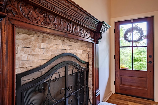 entrance foyer with wood finished floors, plenty of natural light, and baseboards