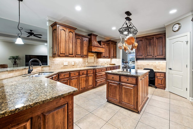 5410 Lexington Ave, Benton, AR 72019 - kitchen featuring custom range hood, ornamental molding, a sink, stainless steel gas cooktop, and backsplash