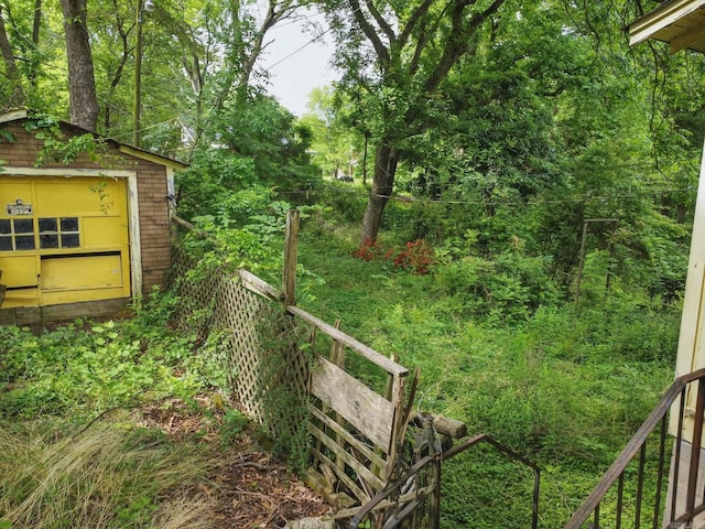view of yard featuring an outbuilding and fence