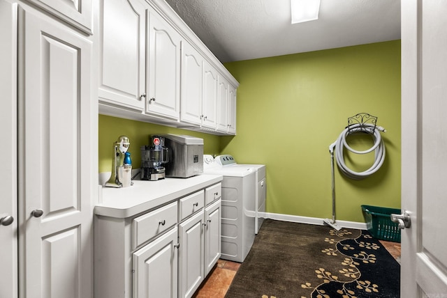 laundry room with independent washer and dryer, cabinet space, and baseboards