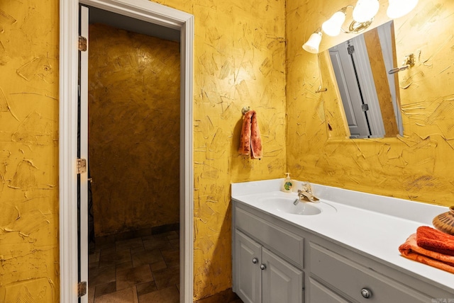 bathroom featuring vanity and stone finish flooring