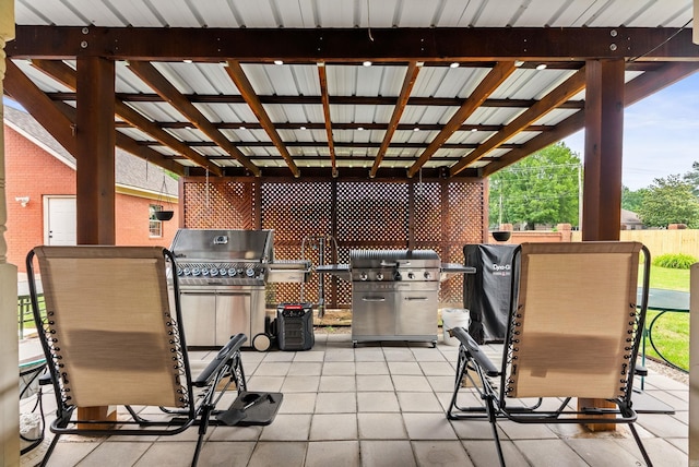 view of patio / terrace featuring a grill and fence