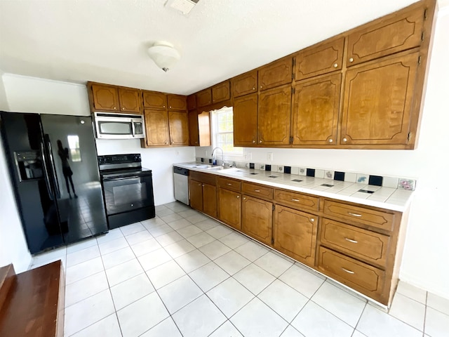 806 Autumnwood Rd, Ash Flat, AR 72513 - kitchen with black appliances, brown cabinets, a sink, and light tile patterned floors