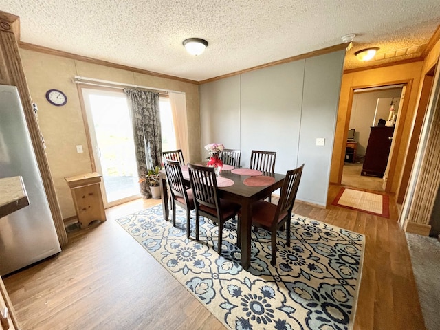 806 Autumnwood Rd, Ash Flat, AR 72513 - dining room featuring crown molding, light wood-style floors, and a textured ceiling