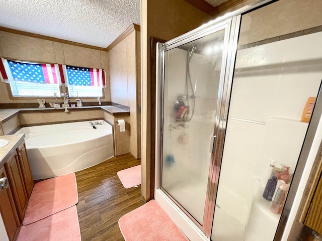 806 Autumnwood Rd, Ash Flat, AR 72513 - full bathroom with crown molding, wood finished floors, a stall shower, a garden tub, and a textured ceiling
