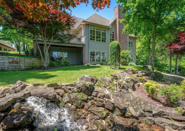 26 Pillar Ln, Hot Springs Village, AR 71909 - rear view of house featuring a chimney, a lawn, and a balcony