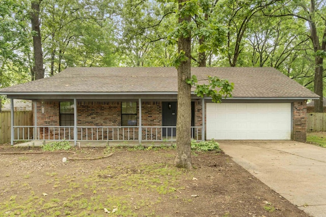single story home featuring brick siding, a porch, a garage, and concrete driveway