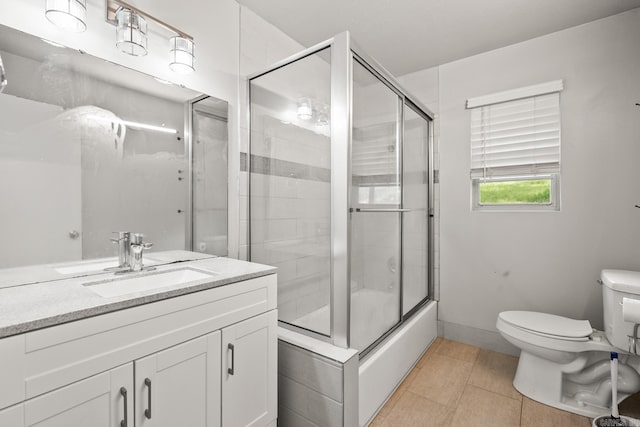 1118 Garland, North Little Rock, AR 72216 - bathroom featuring toilet, vanity, shower / bath combination with glass door, and tile patterned flooring