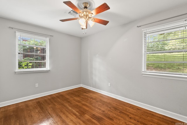 1118 Garland, North Little Rock, AR 72216 - unfurnished room featuring baseboards, healthy amount of natural light, and wood finished floors