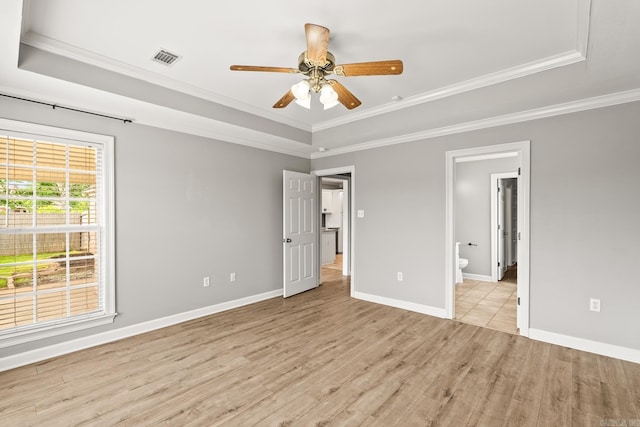 2340 Morning Glory, Conway, AR 72034 - unfurnished bedroom featuring a tray ceiling, crown molding, light wood finished floors, baseboards, and ensuite bathroom
