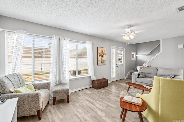 1005 S German, Conway, AR 72034 - living area with wood finished floors, a textured ceiling, a ceiling fan, and baseboards