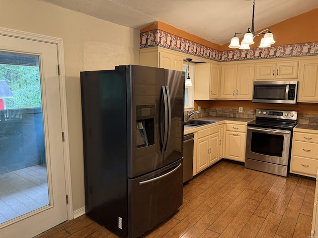 122 Meadow Cliff Cir, Fairfield Bay, AR 72088 - kitchen with stainless steel appliances, wood finished floors, a chandelier, a sink, and decorative light fixtures