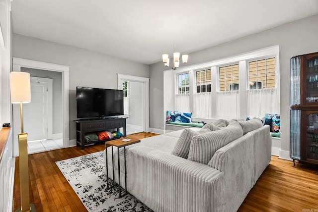 1905 S Battery St, Little Rock, AR 72202 - living area featuring baseboards, wood-type flooring, and a chandelier