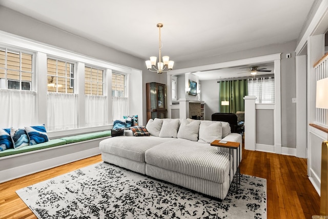 1905 S Battery St, Little Rock, AR 72202 - living area with a chandelier, baseboards, wood finished floors, and a ceiling fan