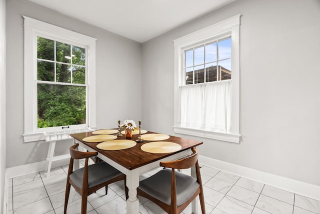 1905 S Battery St, Little Rock, AR 72202 - dining area featuring light marble finish floors, baseboards, and plenty of natural light