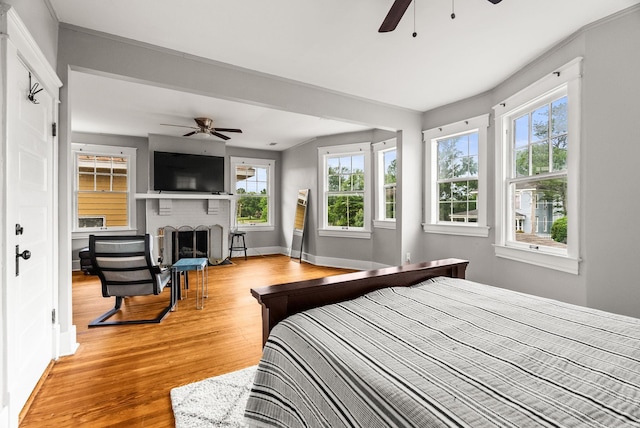 1905 S Battery St, Little Rock, AR 72202 - bedroom with a fireplace, light wood-style floors, and baseboards