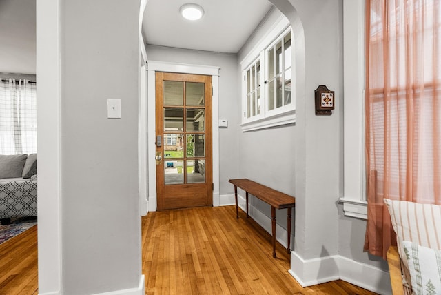 1905 S Battery St, Little Rock, AR 72202 - corridor featuring arched walkways, light wood-type flooring, healthy amount of natural light, and baseboards