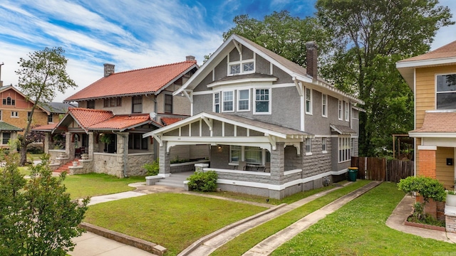 1905 S Battery St, Little Rock, AR 72202 - rear view of property featuring covered porch, stucco siding, a chimney, and stone siding