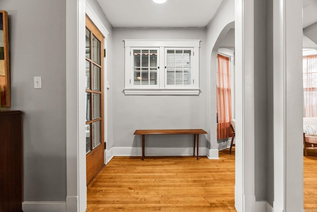 1905 S Battery St, Little Rock, AR 72202 - hall featuring arched walkways, light wood-style flooring, baseboards, and crown molding