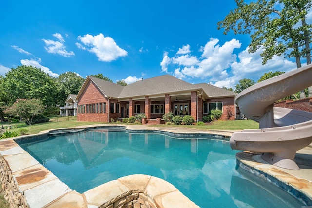 20 Stonegate, Hot Springs, AR 71913 - swimming pool with a water slide, an in-ground hot tub, and a lawn