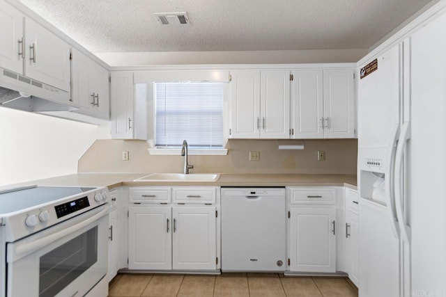 51 Fieldcrest Cir, Cabot, AR 72086 - kitchen with white appliances, a sink, under cabinet range hood, light tile patterned flooring, and white cabinetry