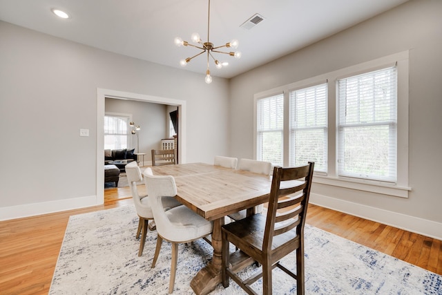 dining area featuring a chandelier, baseboards, light wood-style floors, and recessed lighting