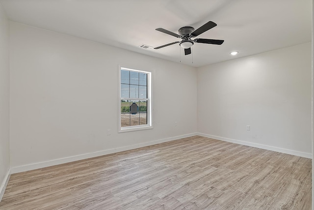 spare room featuring light wood finished floors, baseboards, ceiling fan, and recessed lighting