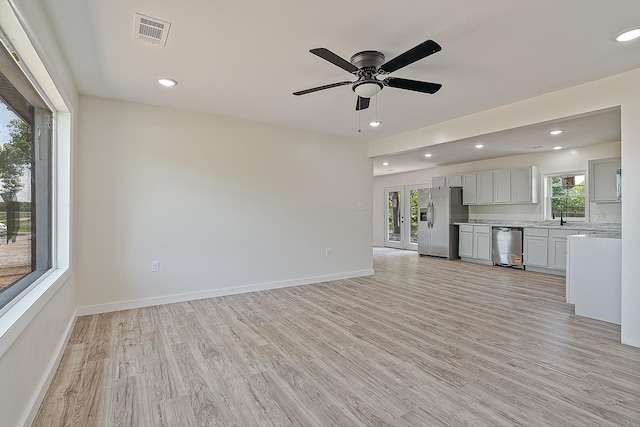unfurnished living room featuring light wood-style floors, recessed lighting, a ceiling fan, and baseboards