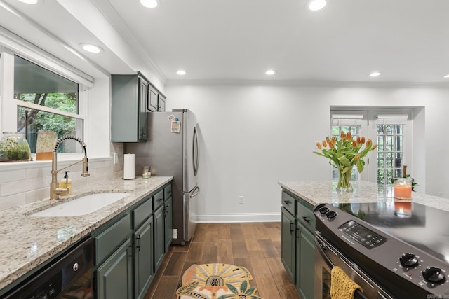 4911 B St, Little Rock, AR 72205 - kitchen with stainless steel appliances, a sink, recessed lighting, crown molding, and dark wood-style floors