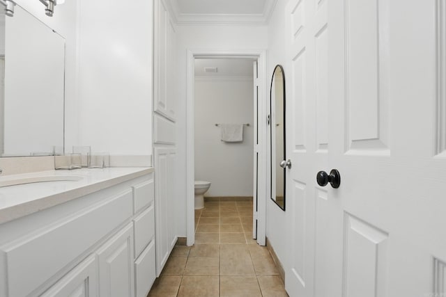 4911 B St, Little Rock, AR 72205 - bathroom featuring crown molding, toilet, vanity, and tile patterned flooring